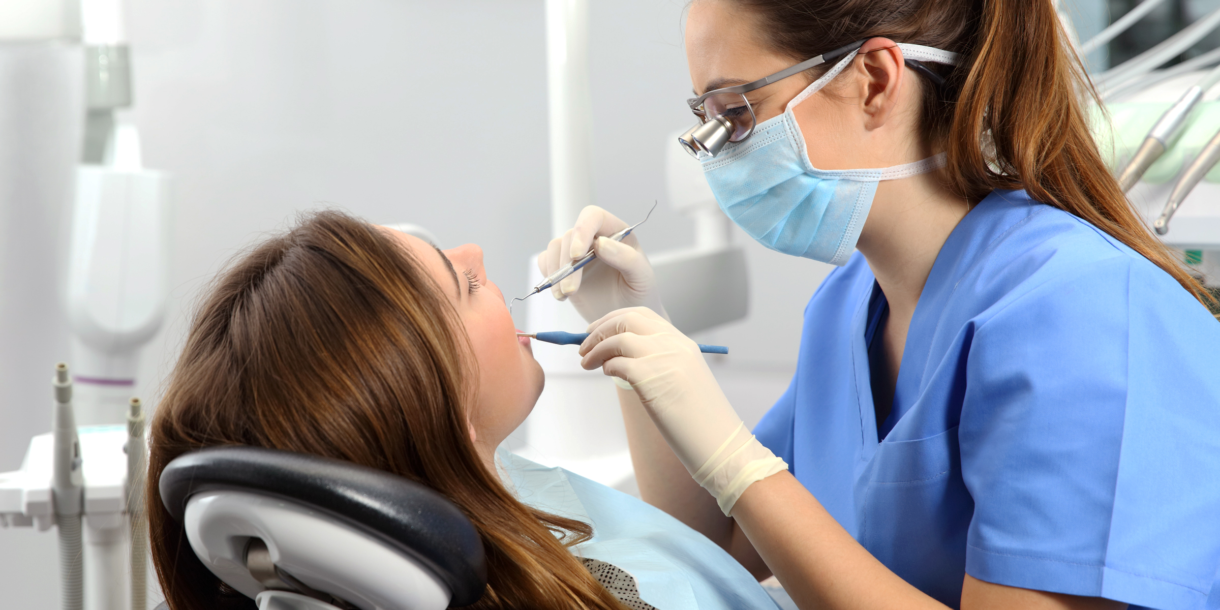 A dental hygienist examining a patient | Source: Shutterstock