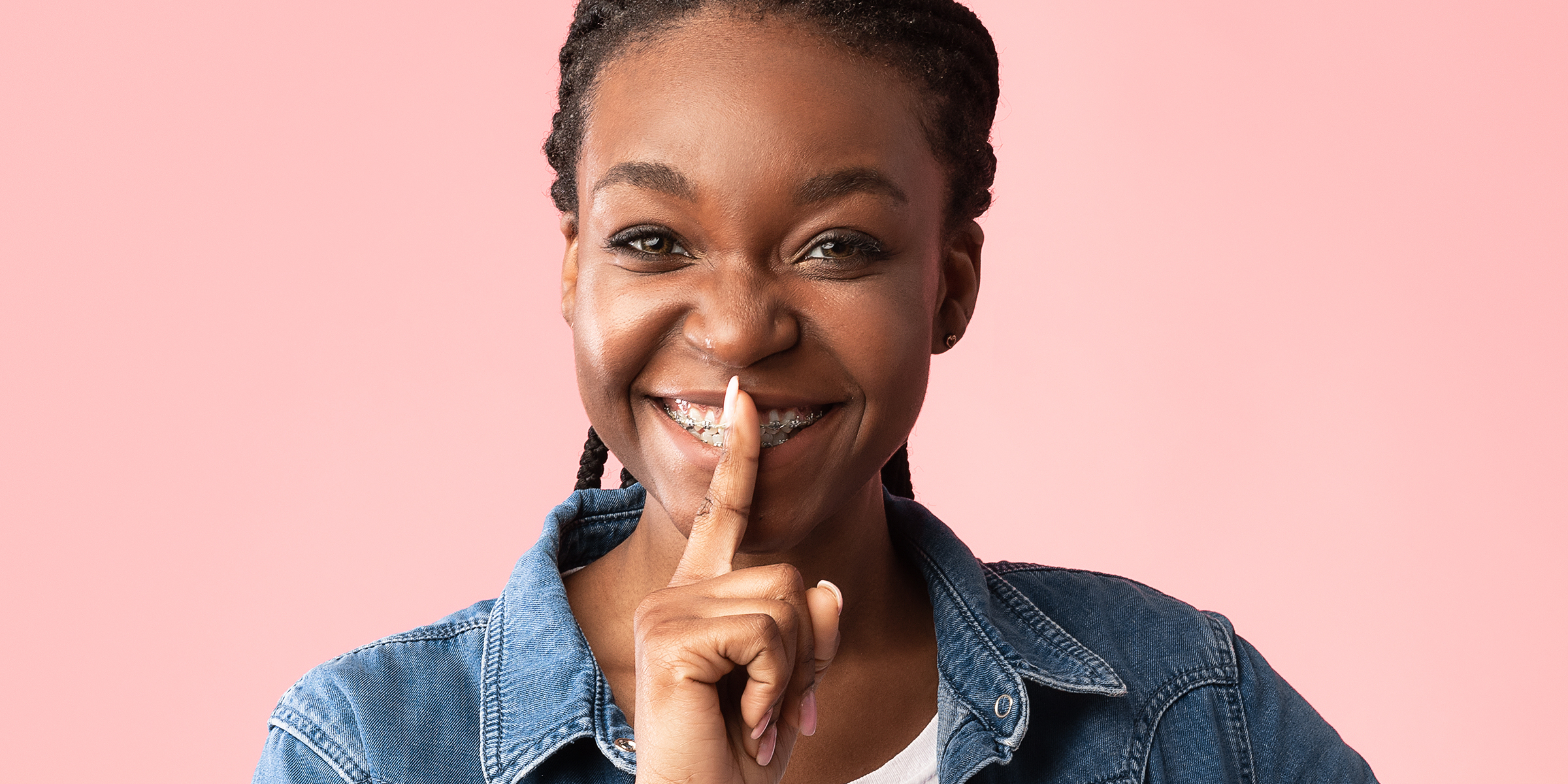 A woman holding her finger to her mouth | Source: Shutterstock