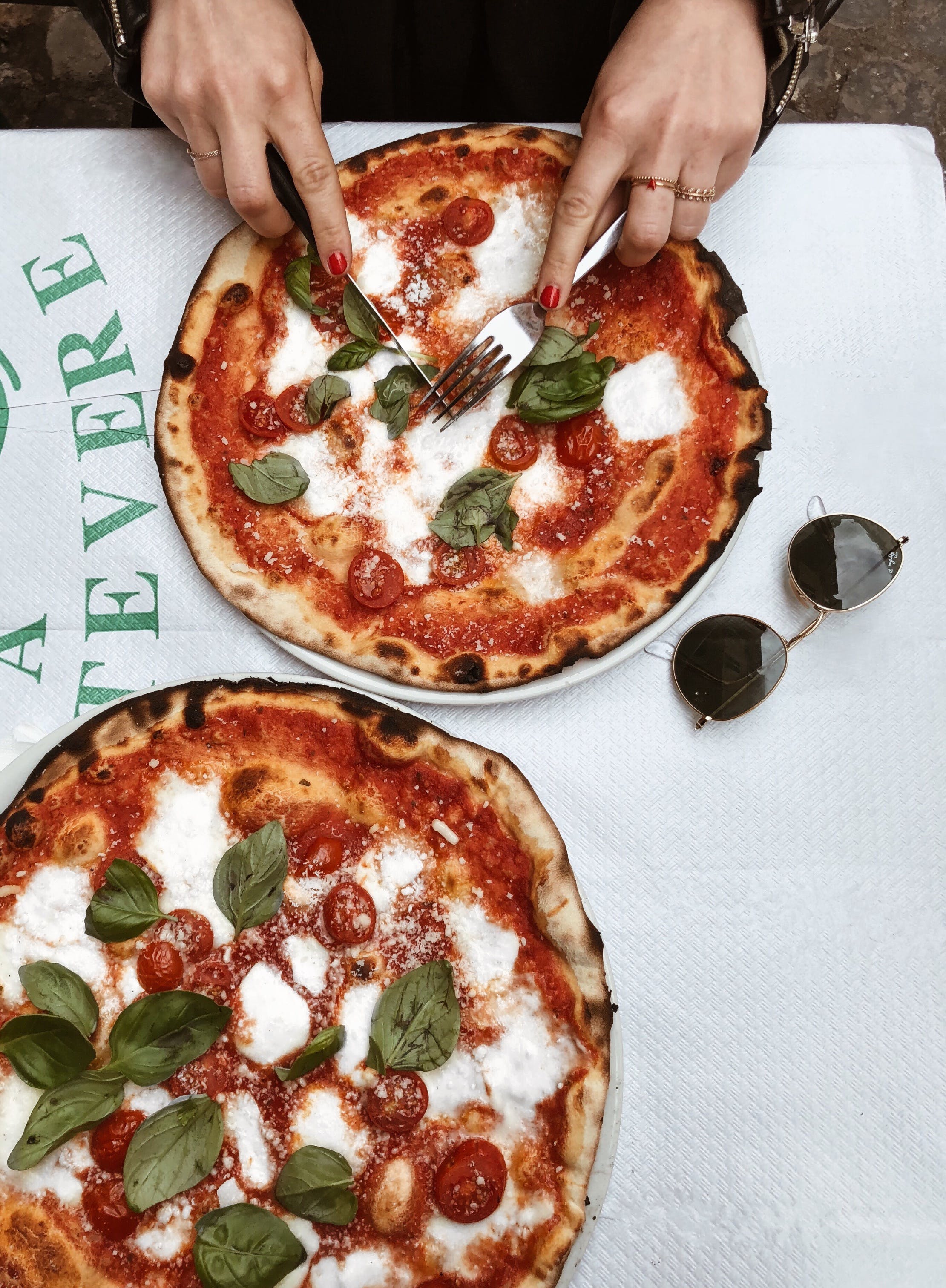 A person savoring two entire pizzas | Source: Pexels
