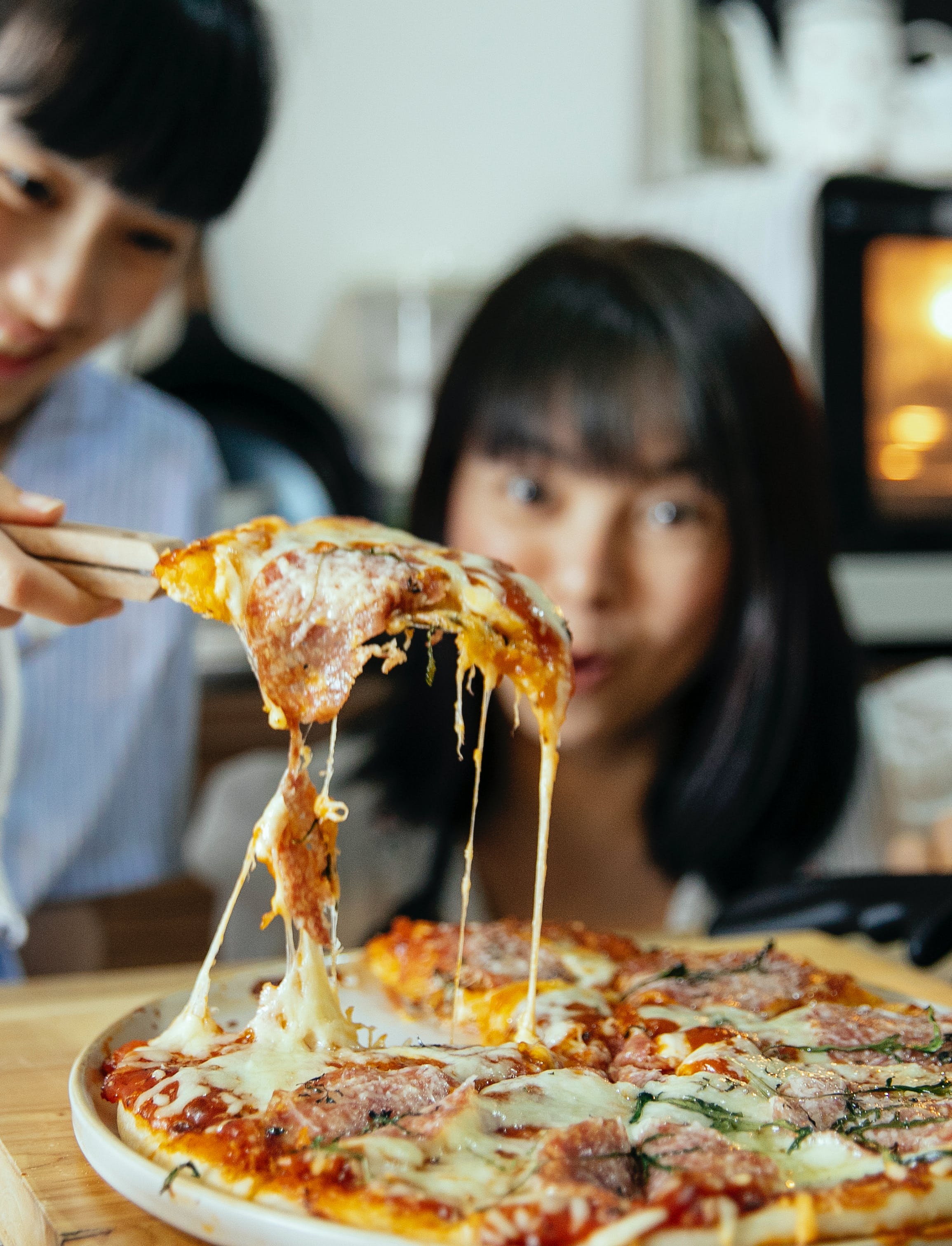 A woman eyes a slice of pizza | Source: Pexels